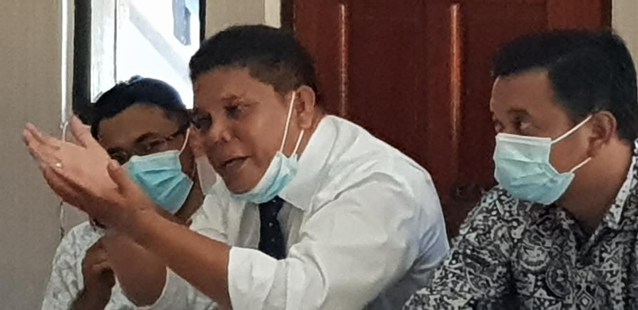 Bapak Raymond Simamora, S.H., M.H. sedang memberikan penjelasan dalam sebuah pertemuan formal didampingi oleh rekan sejawat.