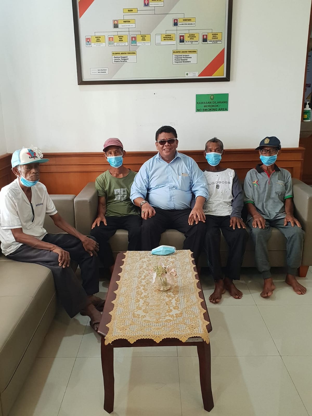 Pelayanan bantuan hukum oleh Raymond Simamora, S.H., M.H. (tengah) dalam sesi pendampingan warga di ruang tunggu sebuah instansi pemerintahan.